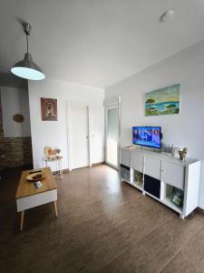 a living room with a television and a table at Casa Moisés Brisa in Cádiz