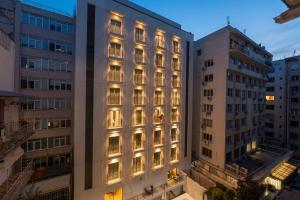 a tall building with its lights on at Studio Ten in Thessaloniki