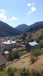 a small town with houses and mountains in the background at Guest House Jani in Trigrad