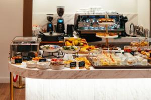 a buffet with many different types of food on a counter at Eternity Athens in Athens