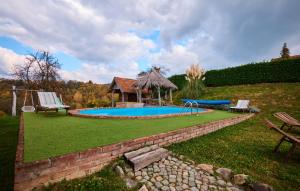 a backyard with a swimming pool and a gazebo at Holiday Home Trnovka by Villas Guide in Veliko Brdo