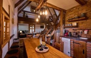 a kitchen with a wooden table in a cabin at Holiday Home Trnovka by Villas Guide in Veliko Brdo