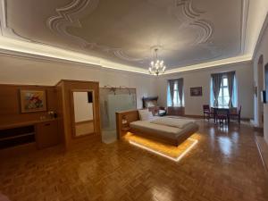 a large living room with a bed and a table at Sobe Proštija in Ptuj