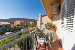a table and chairs on the balcony of a house at Apartments Marija in Cres