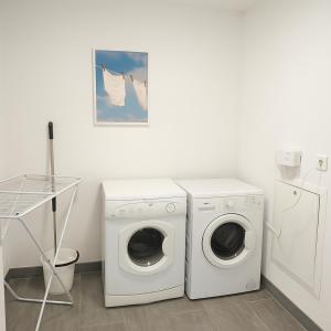 a laundry room with a washing machine and a washer at Aarhus Stay Apartments in Hasselager