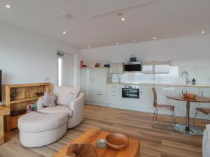 a living room with a couch and a table at Lazy Bulldog in Newport-On-Tay