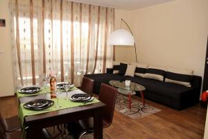 a living room with a couch and a table at Apartments Rosina in Plovdiv