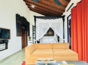 a living room with a couch and a bed at Waterland in Negombo