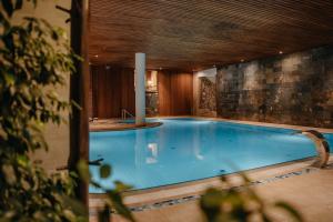 a large swimming pool in a building with at Hotel Partizán in Tale
