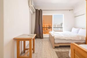a bedroom with a bed and a table and a window at luxury house in Cairo
