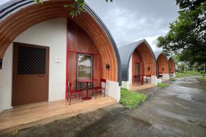 a row of buildings with chairs and a table at Palm Cabanas Resort in Arayat