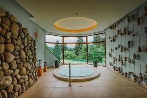 a large bathroom with a large tub in the middle at Hotel Partizán in Tale +83 photos