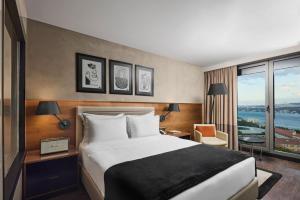 a hotel room with a bed and a large window at Gezi Hotel Bosphorus, Istanbul, a Member of Design Hotels in Istanbul