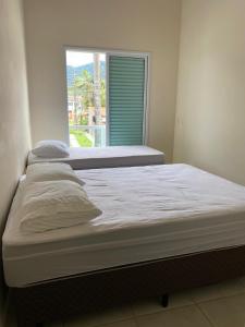 a large bed in a room with a window at Casa charmosa Juquehy in Juquei +17 photos