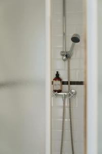 a bathroom with a shower with a floor lamp at Urban Hideout Just Steps from Antwerp's Highlights in Antwerp