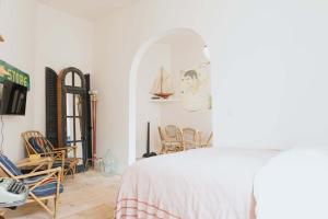 a bedroom with a bed and chairs in a room at Urban Hideout Just Steps from Antwerp's Highlights in Antwerp