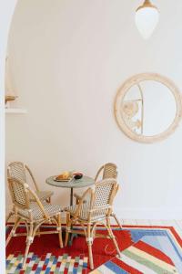 a dining room with a table and chairs and a mirror at Urban Hideout Just Steps from Antwerp's Highlights in Antwerp +23 photos