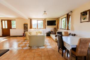 una sala de estar con una mesa y sillas en Vila Verde Păltiniș, en Poplaca
