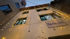 a building with christmas lights and a sign on it at Maa Buu Chhen in Pātan