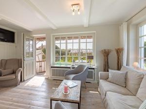 a living room with a couch and a table at Leuchtturmblick-West in Kampen