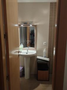 a bathroom with a sink and a mirror at Las torres 1 in Calatayud