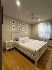 a bedroom with a large bed and a window at Scarborough Stays - Sleeps 8 by the Beachside in Scarborough