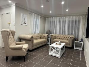 a living room with two couches and a table at Scarborough Stays - Sleeps 8 by the Beachside in Scarborough