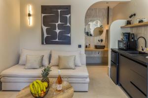 a living room with a couch and a table at Karteris Luxury Suites in Stalís