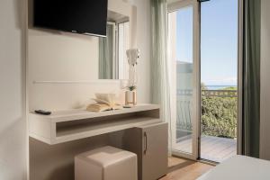 a bedroom with a bed and a view of a balcony at Hotel Caravel B&B in Misano Adriatico