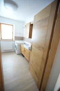 a kitchen with a large wooden door in a room at spacious furnished apartment in Markt Erlbach