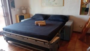 a bed in a bedroom with a brown stuffed animal on it at Appartamento Pietro direttamente sul mare di costa smeralda in Olbia