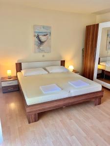 a bedroom with a large bed in a room at Apartmani Fani in Banjol