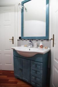 a bathroom with a sink and a mirror at B&B I Cherubini in Cislago