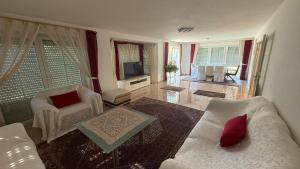 a living room with a couch and a tv at House in Laatzen! contactless check-in in Hannover
