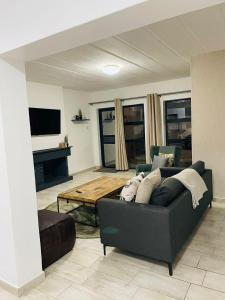 a living room with a couch and a table at Canvas Lofts 1 – Famona modern 2-bed - 2310 in Bulawayo