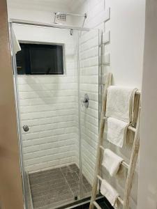 a shower with a glass door in a bathroom at Canvas Lofts 1 – Famona modern 2-bed - 2310 in Bulawayo