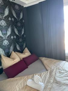 a bed with a towel on it in a bedroom at Apartmenthaus in der Delitzscher Str in Halle-Saale nähe Hauptbahnhof in Halle an der Saale +6 photos