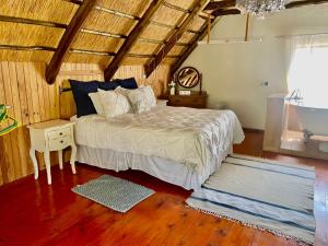 Stunning private cottage in the heart of Nyanga - 2095 في Juliasdale: غرفة نوم مع سرير وأرضية خشبية