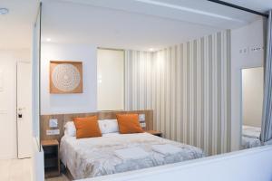 a bedroom with a bed and a mirror at Apartamentos Marqués de Abastos in Logroño