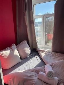 a room with two beds and a window at Apartmenthaus in der Delitzscher Str in Halle-Saale nähe Hauptbahnhof in Halle an der Saale