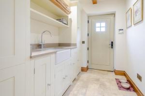 a kitchen with white cabinets and a sink and a door at 2 Bed in Upper Quinton oc-p33608 in Mickleton +25 photos