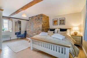 a bedroom with a large bed and a stone wall at 5 Bed in Cleeve oc-t33614 in Brockley