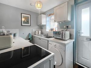 a kitchen with a sink and a microwave at Clarks Yard in Whitby