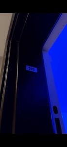 a close up of a blue door with a sign on it at Chambre privée chez l habitant Jardin et Transats in Noisy-le-Sec +10 photos