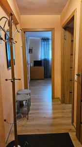 a room with a hallway with a chair and a door at MINiLUx in Ventspils +9 photos