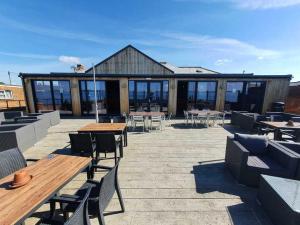 a patio with tables and chairs and a building at 13 West Drive in Warsash