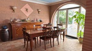 a dining room with a wooden table and chairs at La Vecchia Taverna - Hotel Restaurant Catering in Oliveto Citra