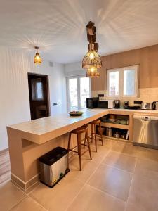 a kitchen with a large wooden table in a room at Casa Campo 10 min de Puy de Fou in Guadamur