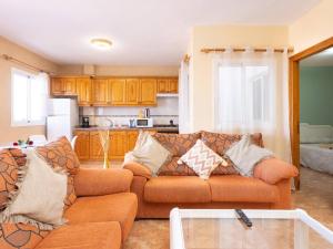 a living room with a couch and a kitchen at Live La Caleta Las Salinas con vista al mar 2 in Caleta de Interián