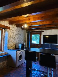 a kitchen with a washer and dryer in a house at Gite en chartreuse in Proveysieux